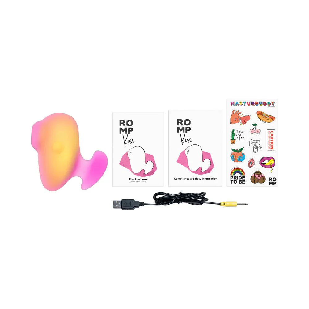 Pink ROMP Kiss Clitoral Stimulator with accessories, manuals, and stickers for compact pleasure and travel convenience.