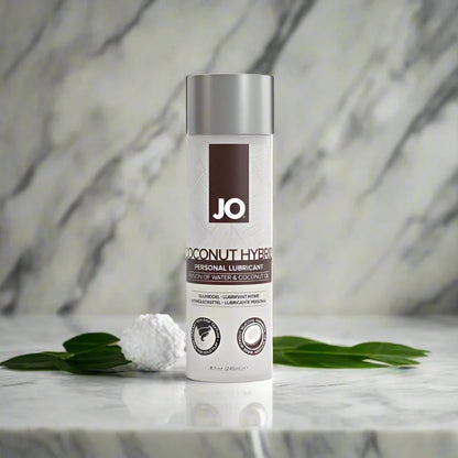 A bottle of JO Coconut Hybrid Original Lubricant with a white label and silver cap, prominently displaying the brand logo 'JO' at the top.